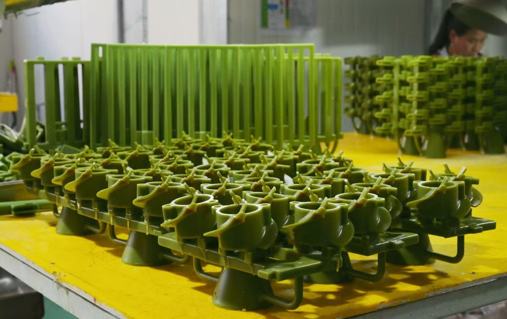 Wax pattern assembly for silica sol investment casting showing multiple wax patterns attached to a central sprue tree at Aohai Precision